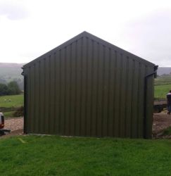 Steel cladding in place on agricultural storage building